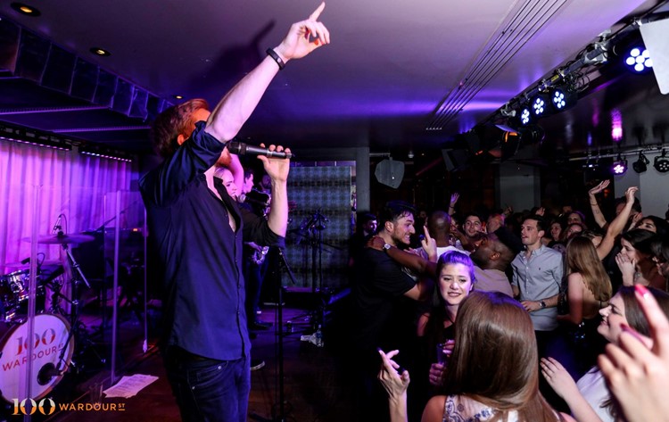 100 wardour st london famous singer having a concert show entertaining group of people crowd having fun dancing and drinking