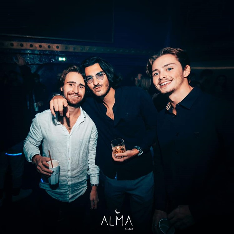 Alma nightclub Paris handsome guys having fun vip table reservation book yours now