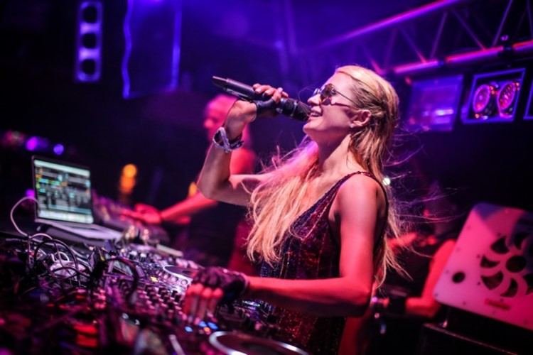 amnesia nightclub ibiza celebrity paris hilton being a dj playing music and singing in the microphone pretty blonde girl having fun making music