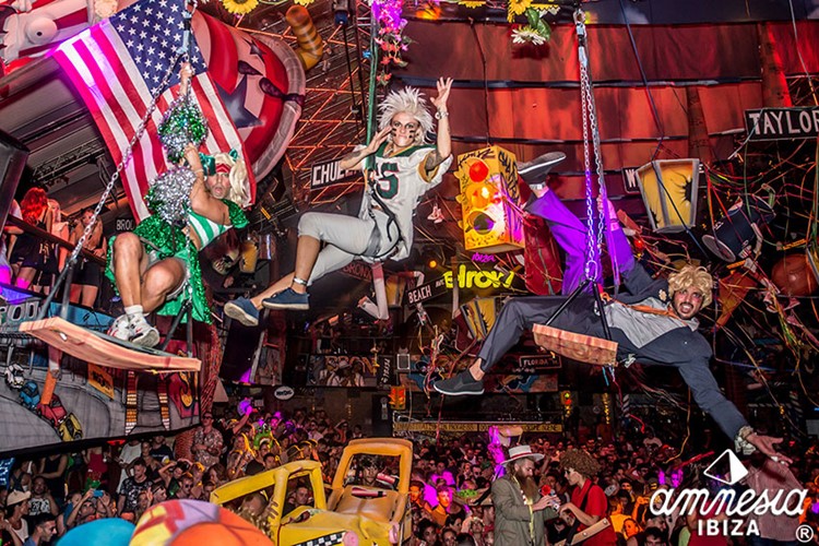 Amnesia nightclub Ibiza acrobats on swinging chairs dressed in costumes