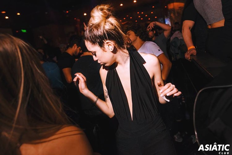 Asia de Cuba nightclub Buenos Aires blonde girl dancing having fun in black dress