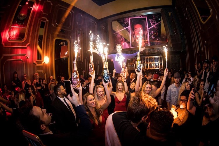 Avenue nightclub New York waitresses holding champagne bottles party show