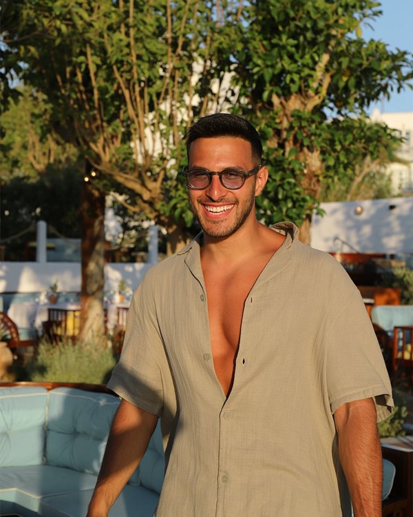 Bagatelle club in Mykonos handsome guy relaxed outfit day time partying