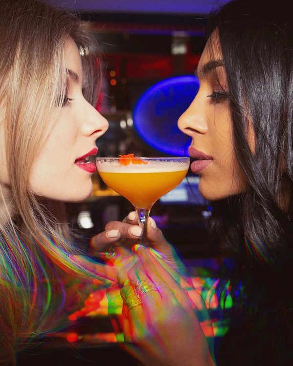 Bagatelle restaurant New York City pretty brunette blonde girls red lipstick drinking cocktails orange vodka rum gin