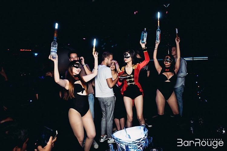 Bar Rouge nightclub Singapore pretty waitresses in costumes celebrate champagne vodka alcohol bottles vip table book now