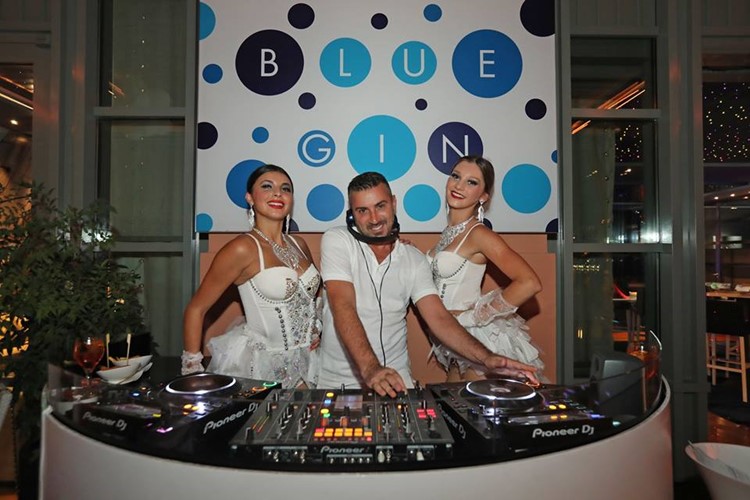 Blue Gin nightclub Monaco dj mixing music with two brunette sexy girls all dressed in white