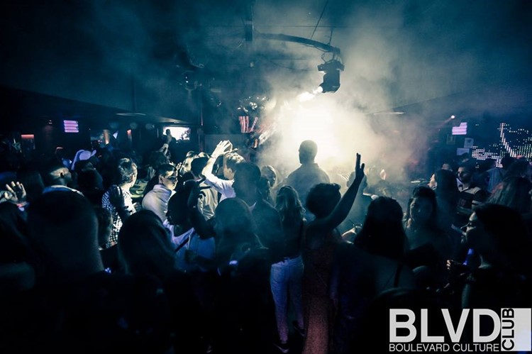Boulevard nightclub Barcelona full night party crowd of people having fun and dancing smoke special effects