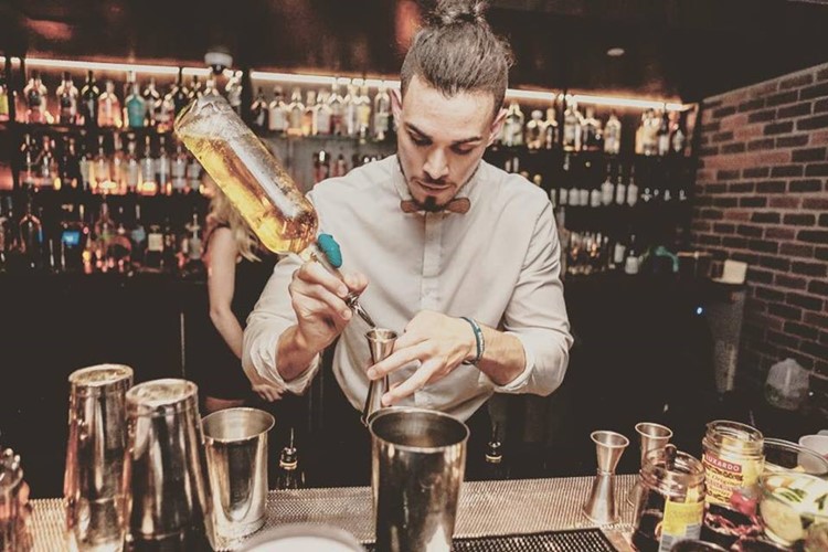 Bourbon and Banter nightclub Dallas barman mixing drinks alcohol cocktails gin vodka rum bottles