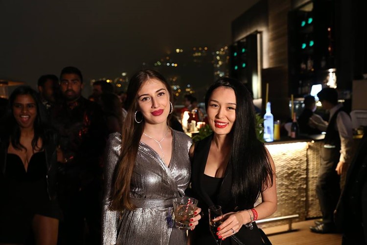 Ce La Vi nightclub Hong Kong two pretty brunette women wearing dresses drinking alcohol