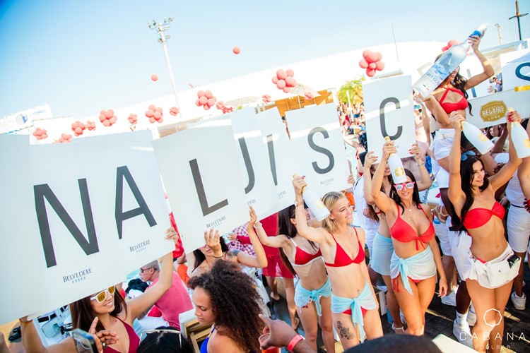 Cabana Pool Bar club Toronto sexy girls dressed in red swimsuits holding a sign