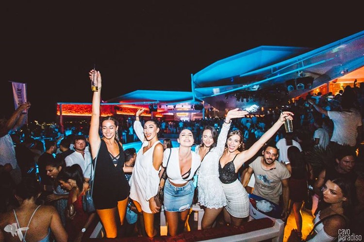 Cavo Paradiso nightclub Mykonos full night party five pretty girls dancing and having fun dressed in mini skirts drinking alcohol