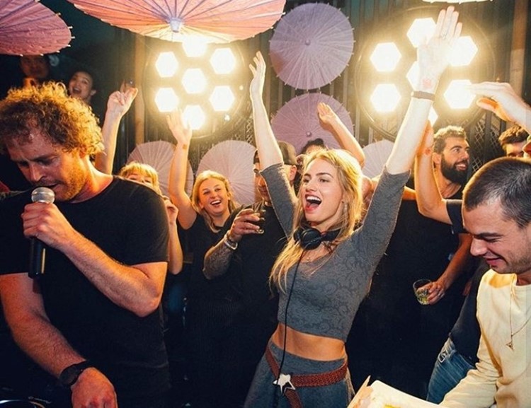 Chin Chin nightclub Amsterdam blonde girl dressed in grey skirt headphones dj mixing music