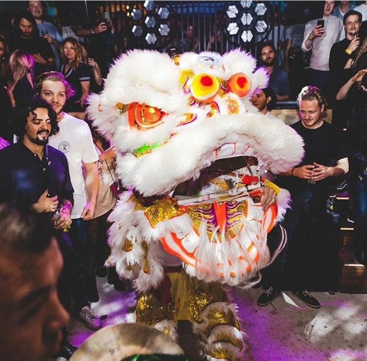 Chin Chin nightclub Amsterdam boys next to dragon head decoration traditional
