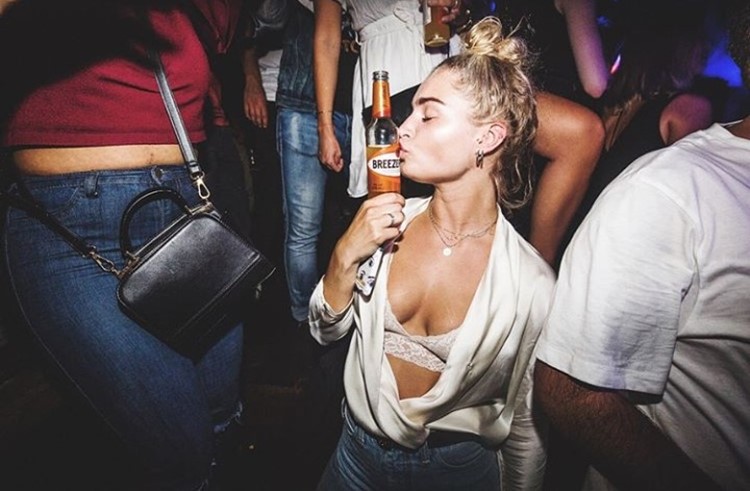 Chin Chin nightclub Amsterdam blonde girl kissing bottle of alcohol dressed sexy