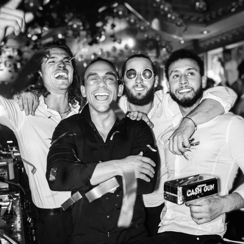 Chrystie nightclub Cannes beautiful brunette girl dressed in pale pink dress and high heels on big chair