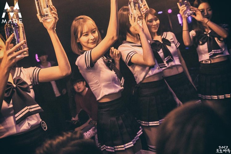 Club Made nightclub Seoul sexy waitresses bringing alcohol bottles dressed in costumes anime shoolgirl vodka gin champagne luxury