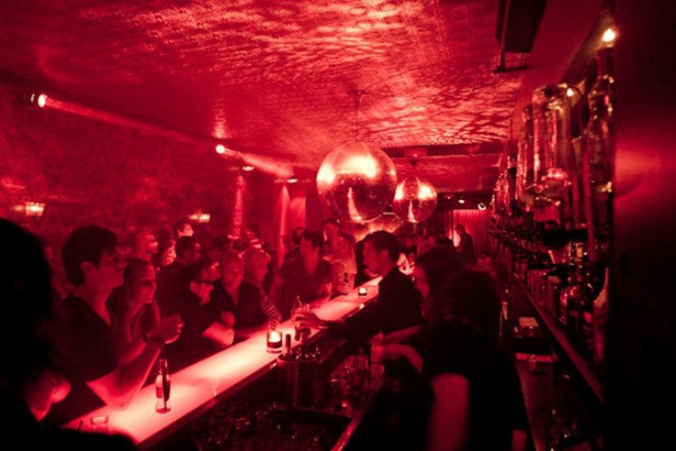 Club NL nightclub Amsterdam view of the bar people having drinks red lights