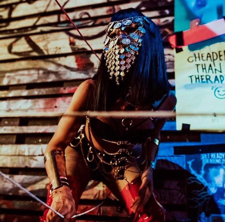 Club Nyx nightclub Amsterdam exotic dancer wearing metal face mask dressed in silver chains