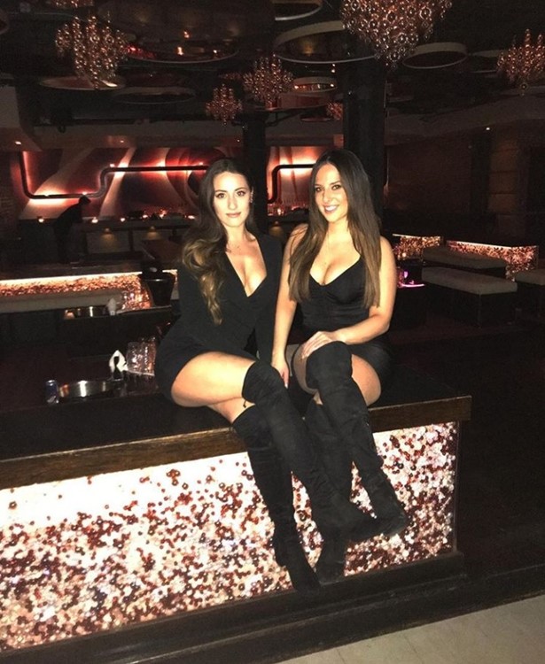 Cuvee nightclub Chicago two brunette girls dressed in black mini dresses and high knee boots