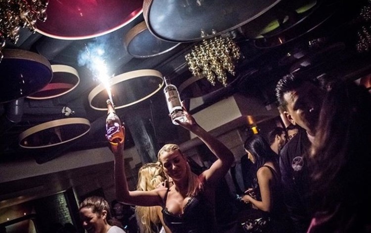 Cuvee nightclub Chicago waitress big boobs blonde girl holding alcohol bottles