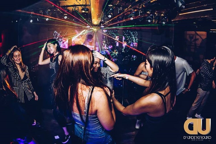 D'Underground nightclub Singapore party girls dancing having fun drinking alcohol
