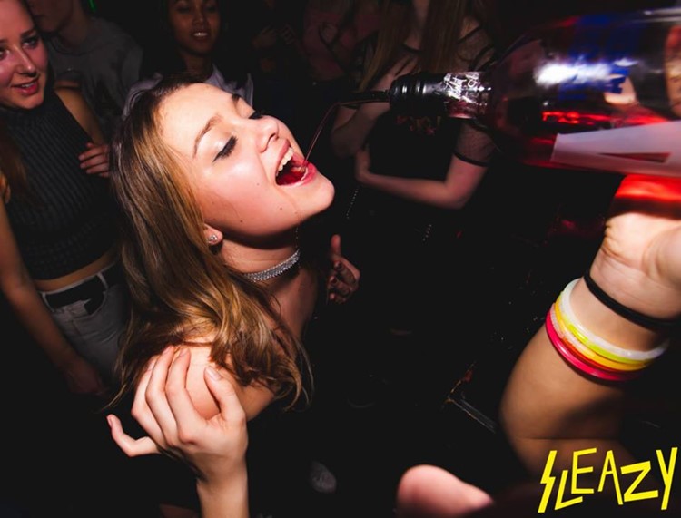 De ClubUp nightclub Amsterdam brunette girl getting alcohol poured in her mouth big bottle