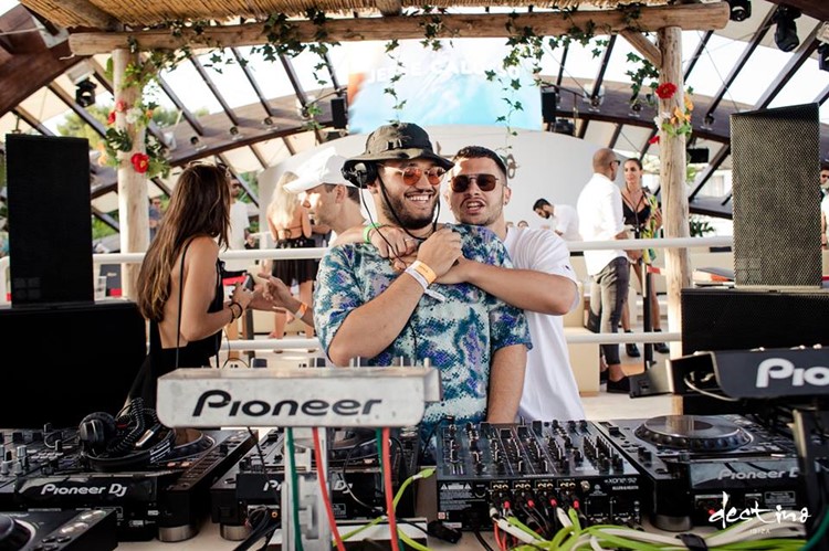 Destino nightclub Ibiza two djs having fun mixing music at concert event