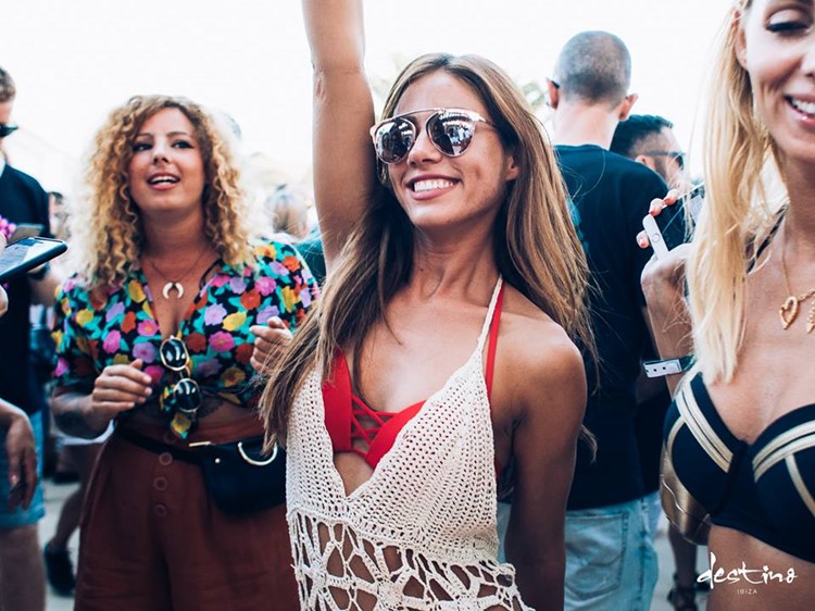 Destino nightclub Ibiza pretty brunette girl having fun dancing in red swimsuit