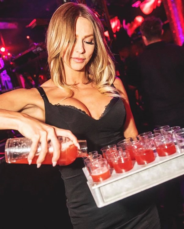 Drais nightclub Las Vegas sexy blonde waitress pouring cocktails shots alcohol drinks mini black dress