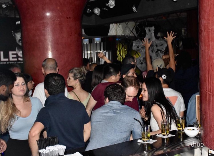 Drop nightclub Hong Kong people sitting at bar having drinks