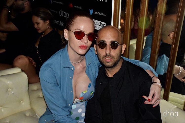 Drop nightclub Hong Kong pretty woman showing cleavage with man dressed in black