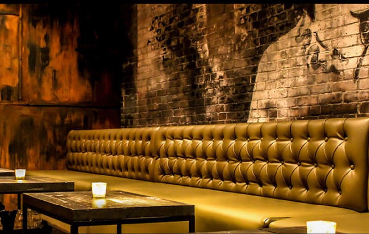 EFS SOCIAL CLUB nightclub Toronto corner view of lounge area gold couch and edgy walls