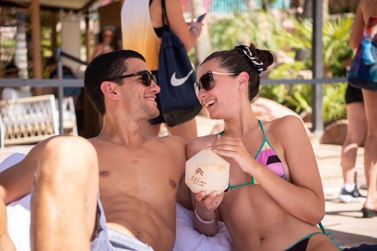 Elia beach club Las Vegas couple enjoying drinks alcohol book sunbed cabana vip table