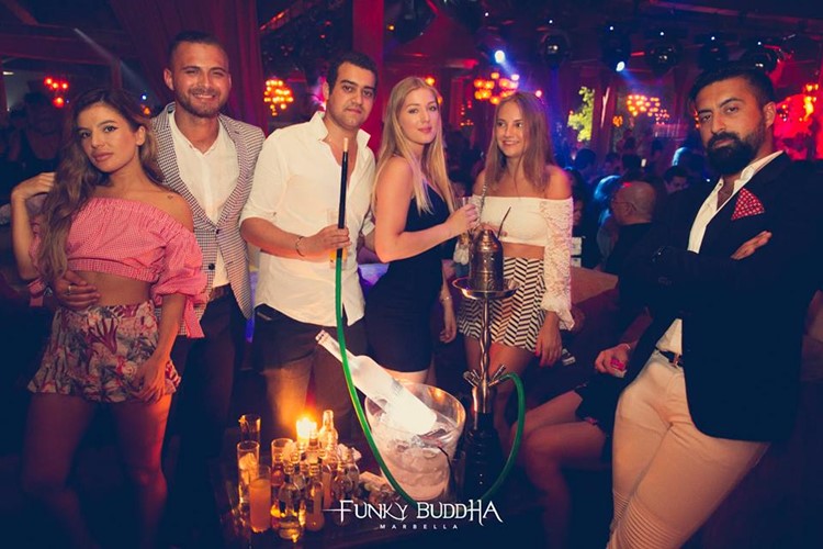 Funky Buddha nightclub Marbella girls and men having fun table booking reservation book now vip area alcohol bottles sit down luxury style dresscode