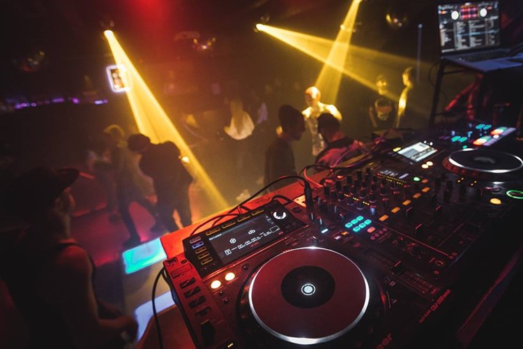 Garage club nightclub Moscow djs mixing music dance floor people having fun drinking