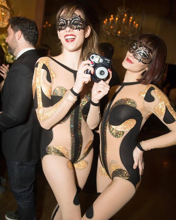 Goldbar nightclub New York City gold luxurious interior design two girls dressed in black and white costumes having fun