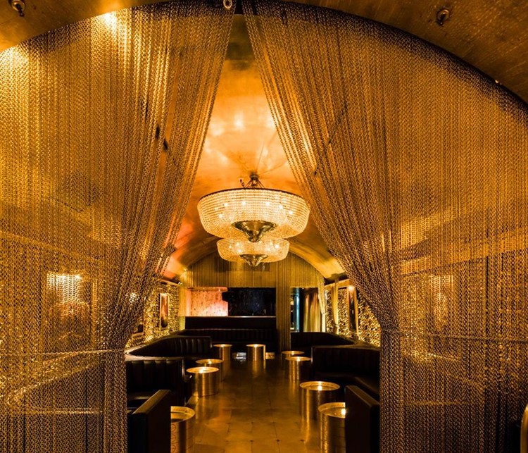 Goldbar nightclub New York City gold luxurious interior design chain curtain lounge area bar