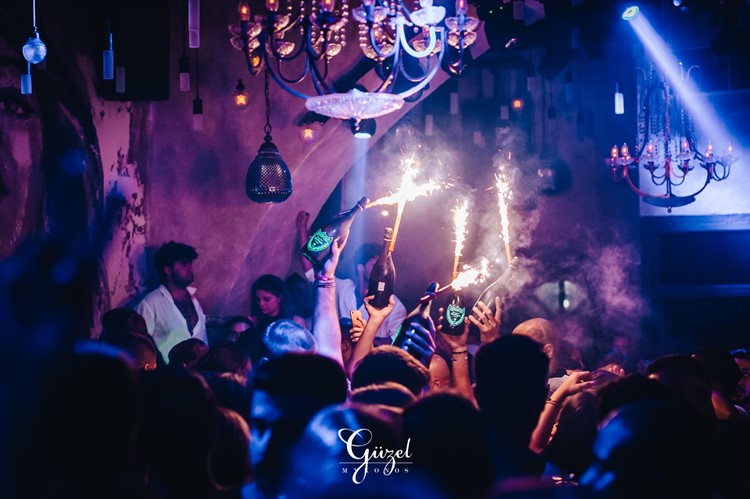 Guzel nightclub Mykonos celebrate birthday hen bachelor parties champagne parade alcohol bottles