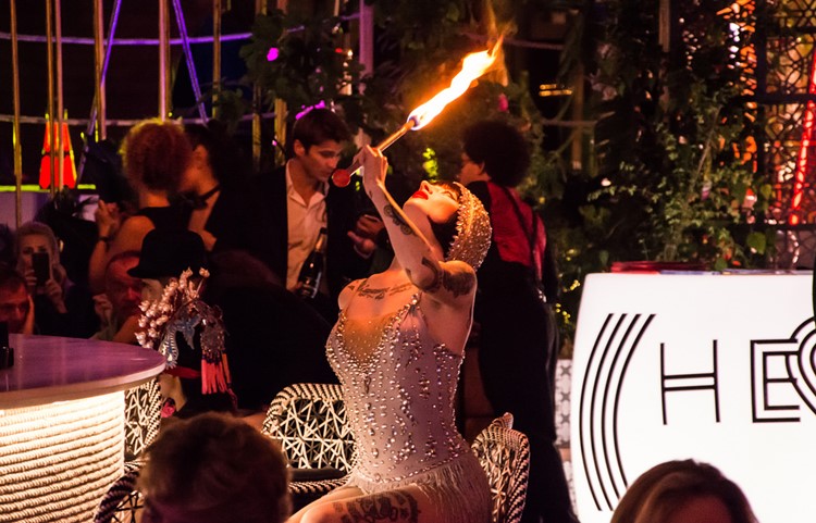 Heart nightclub Ibiza exotic dancer playing with fire dressed in 20s costume white pearls