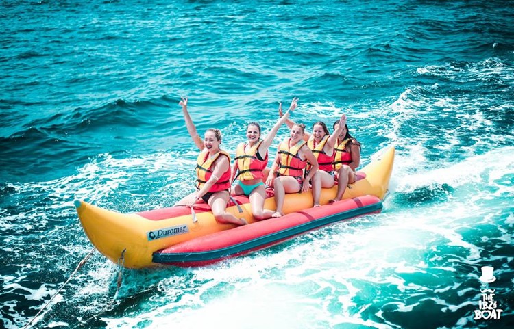 IBZ Boat Party Ibiza girls having fun on banana boat