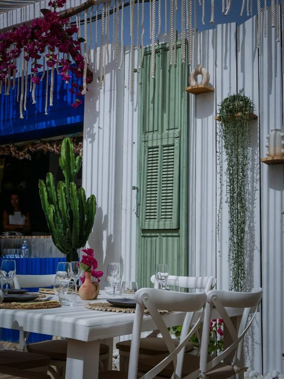 Kalamata Beach club St Tropez outdoor terrace tables cosy boho restaurant