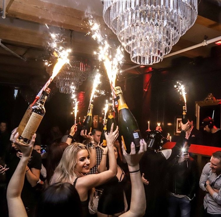 Key Club nightclub Chicago girls holding bottles of alcohol champagne