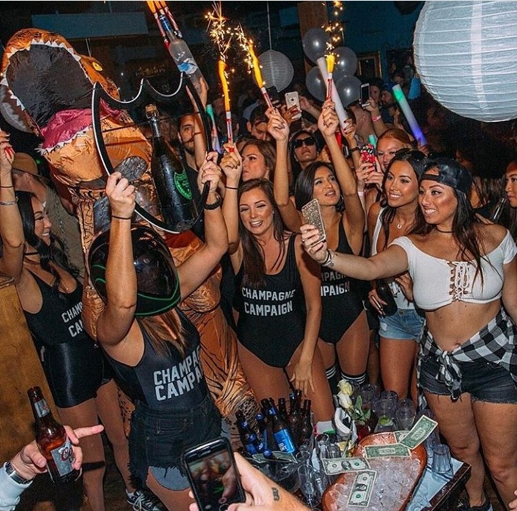 Key Club nightclub Chicago girls dressed in black swimsuits holding alcohol bottles