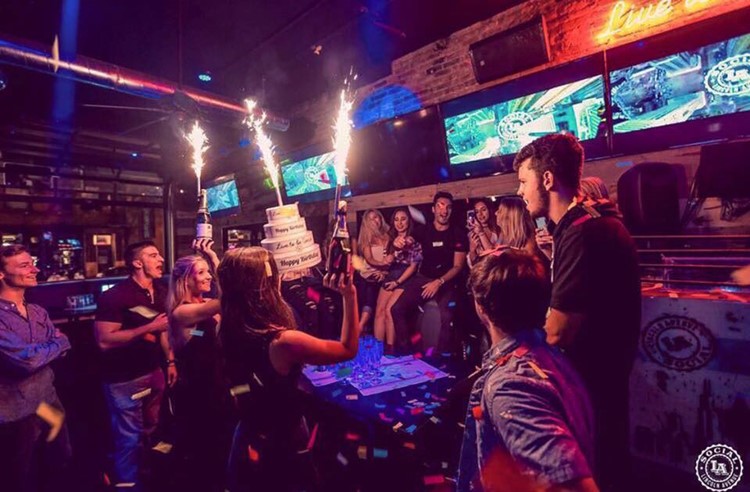 LA Social sports club Chicago fun party people celebrating big bottles of champagne vodka
