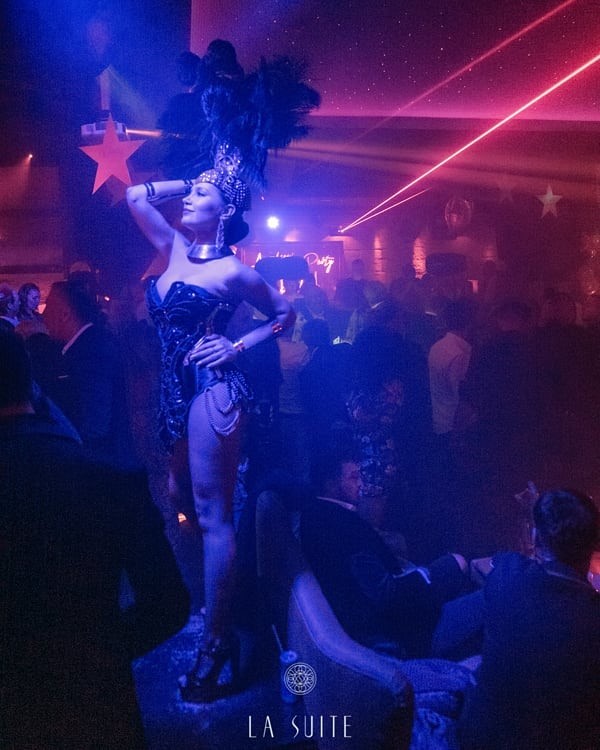 La Suite nightclub Marbella sexy exotic dancer in feather costume on stage posing dancing