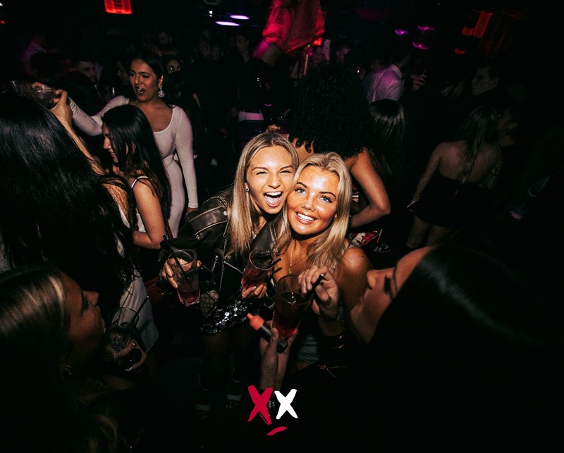 Luxx nightclub London pretty people boy and girl brunette all black outfits chic casual partying