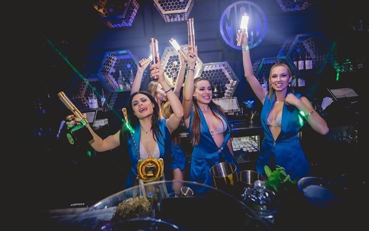 Mad Club Wynwood Miami girls having fun go out alcohol bottles table