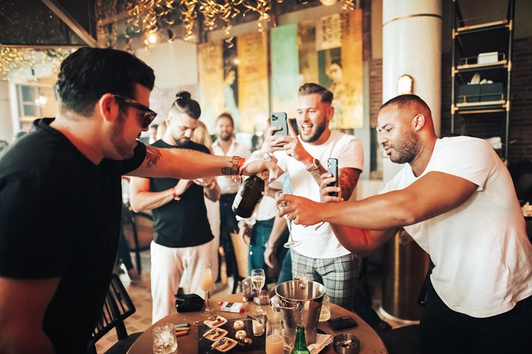 Maiden Shanghai restaurant club Dubai guys having fun celebrate party champagne bottles alcohol book vip table