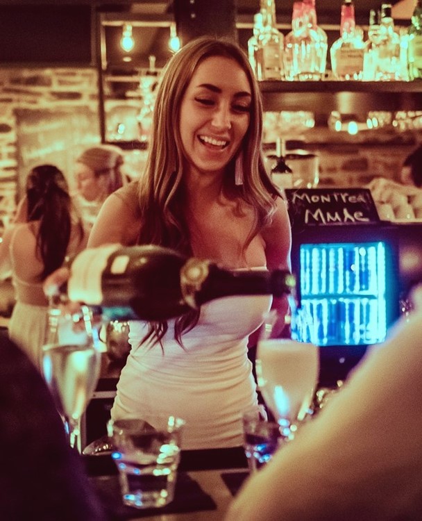 Maison Saint Paul nightclub Montreal waitress serving drinks alcohol cocktails champagne vodka gin rum luxury elegant place