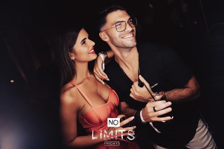 Mantis nightclub Dubai sexy brunette girl with guy having fun drinking cocktails